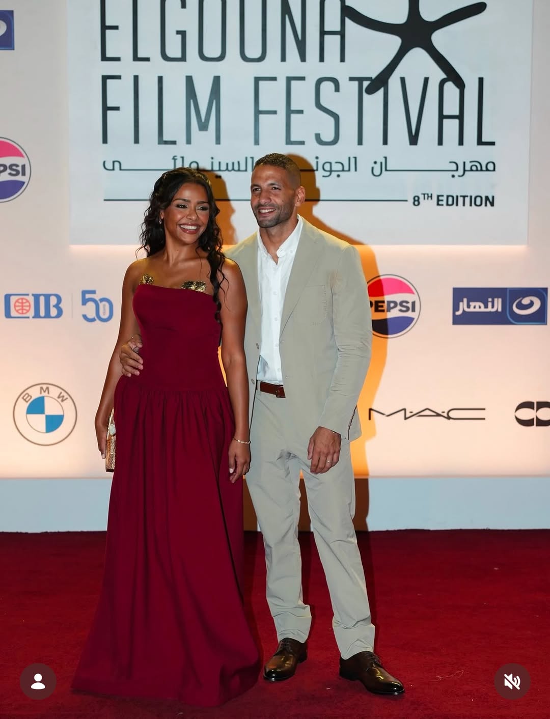 أسماء أبو اليزيد بفستان طويل باللون الأحمر الداكن