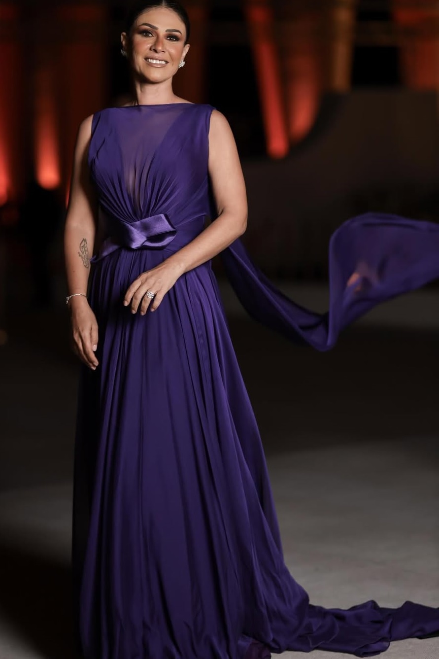 بسمة بفستان انسيابي طويل باللون البنفسجي