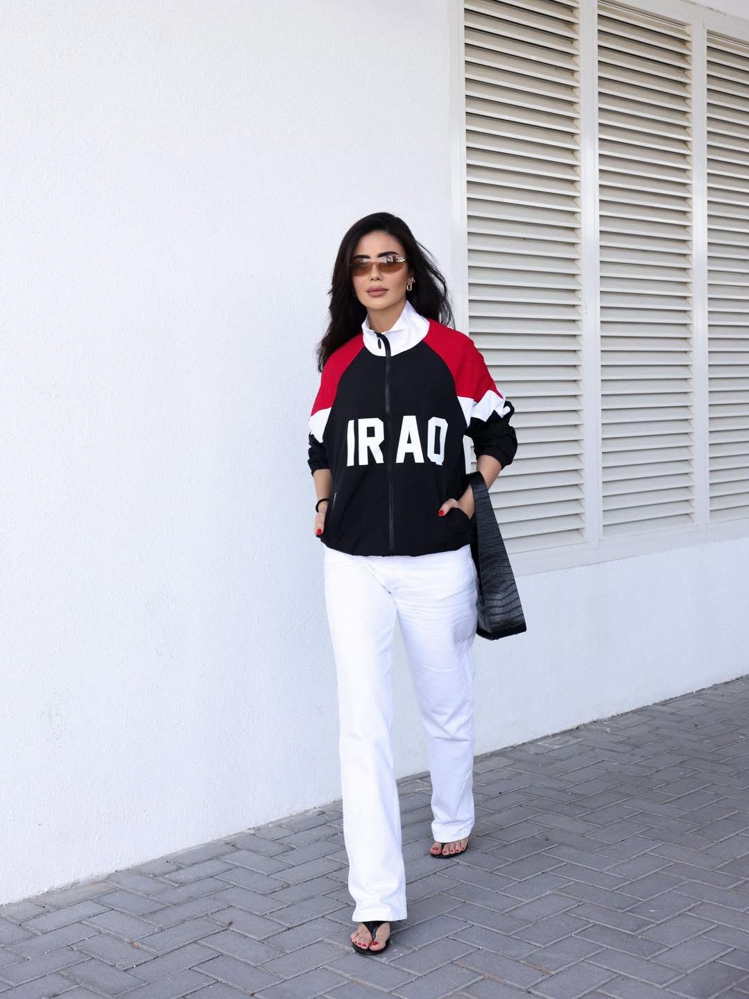 ديما الأسدي ببنطال مستقيم باللون الأبيض مع جاكيت رياضي مريح باللون الأسود