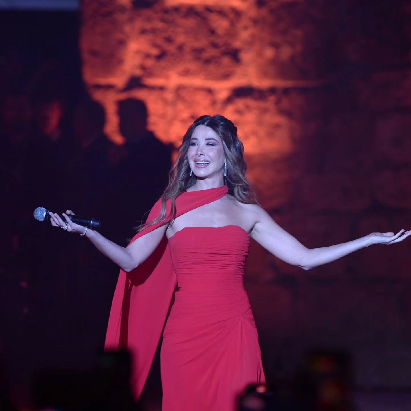 نانسي عجرم بفستان سهرة طويل باللون الأحمر الناري بقصة سترابلس بتصميم درابيه