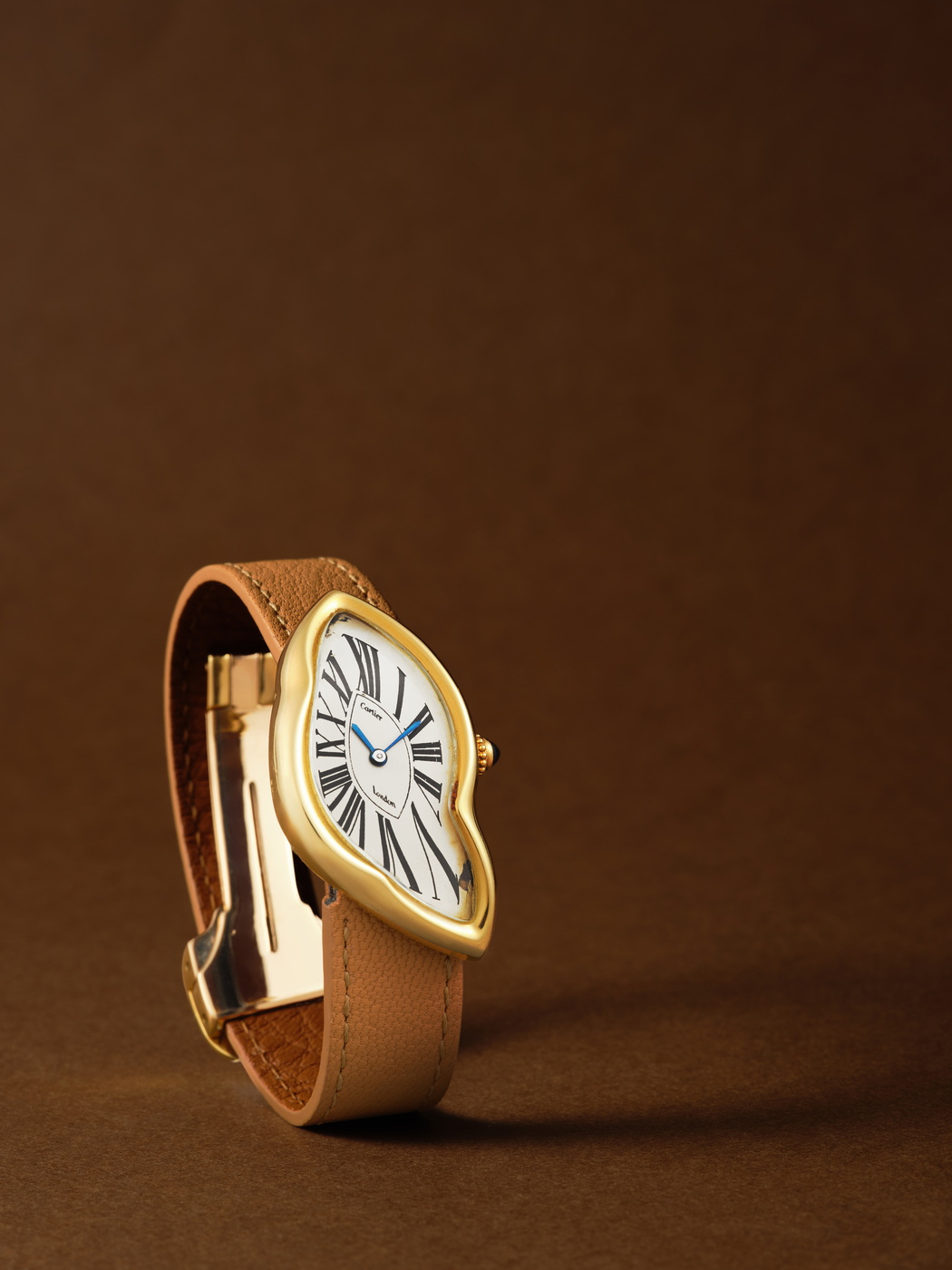 Cartier Crash, London_yellow gold distorted oval wristwatch made in 1987, accompanied by its gold buckle, est $400k -800k