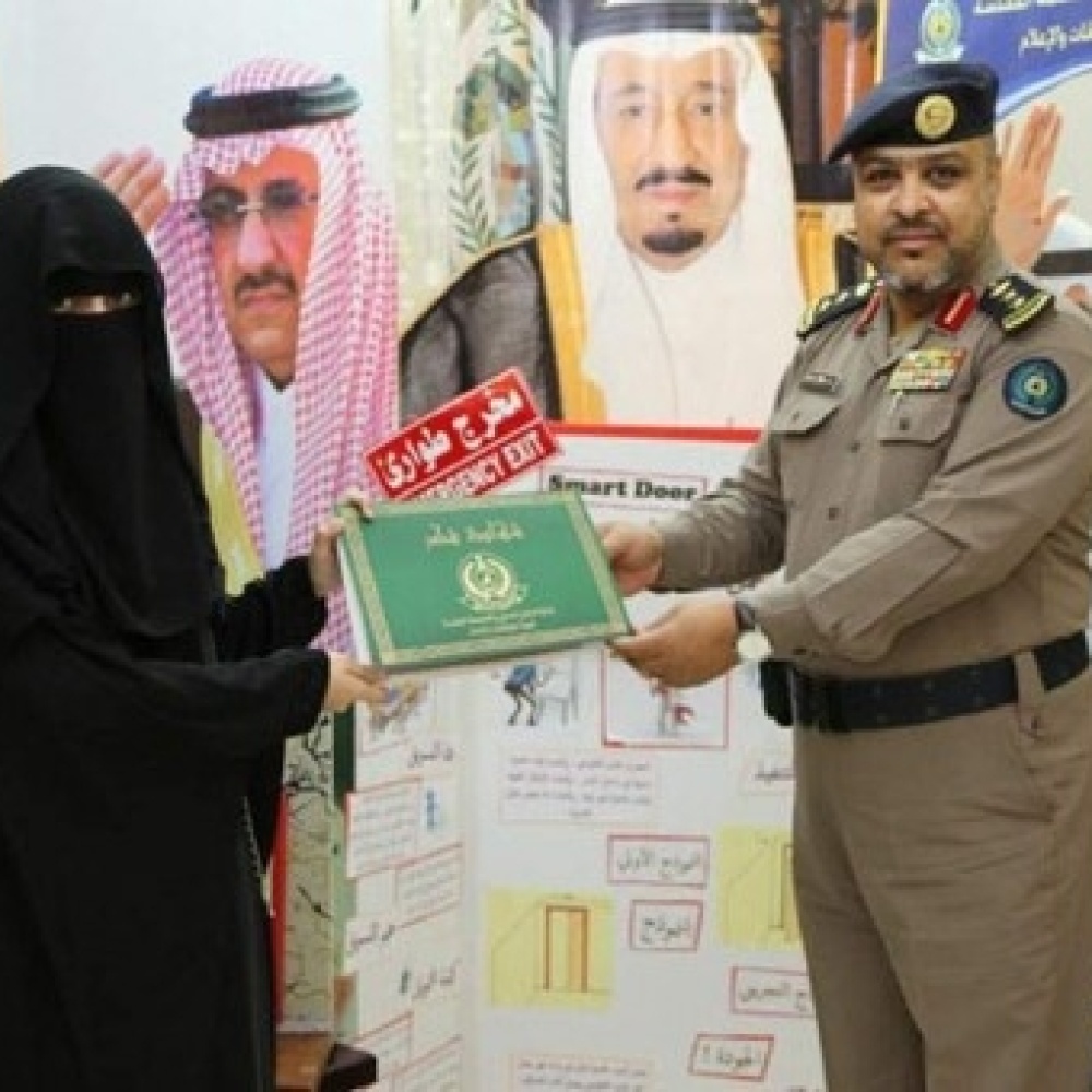 الطالبة تتسلم شهادة شكر من العقيد الزايدي