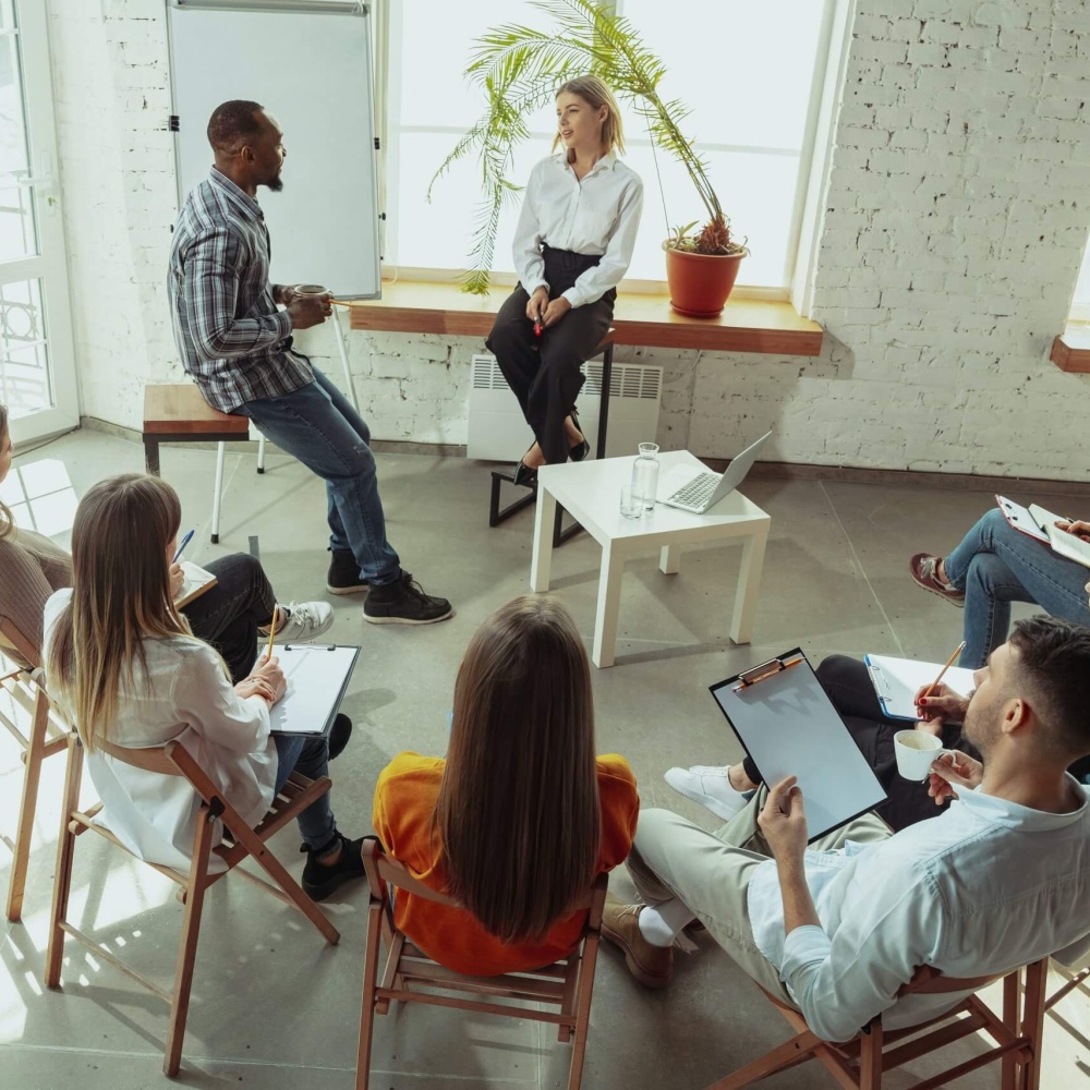 consultant-running-a-small-workshop-with-a-team-of-employees-scaled