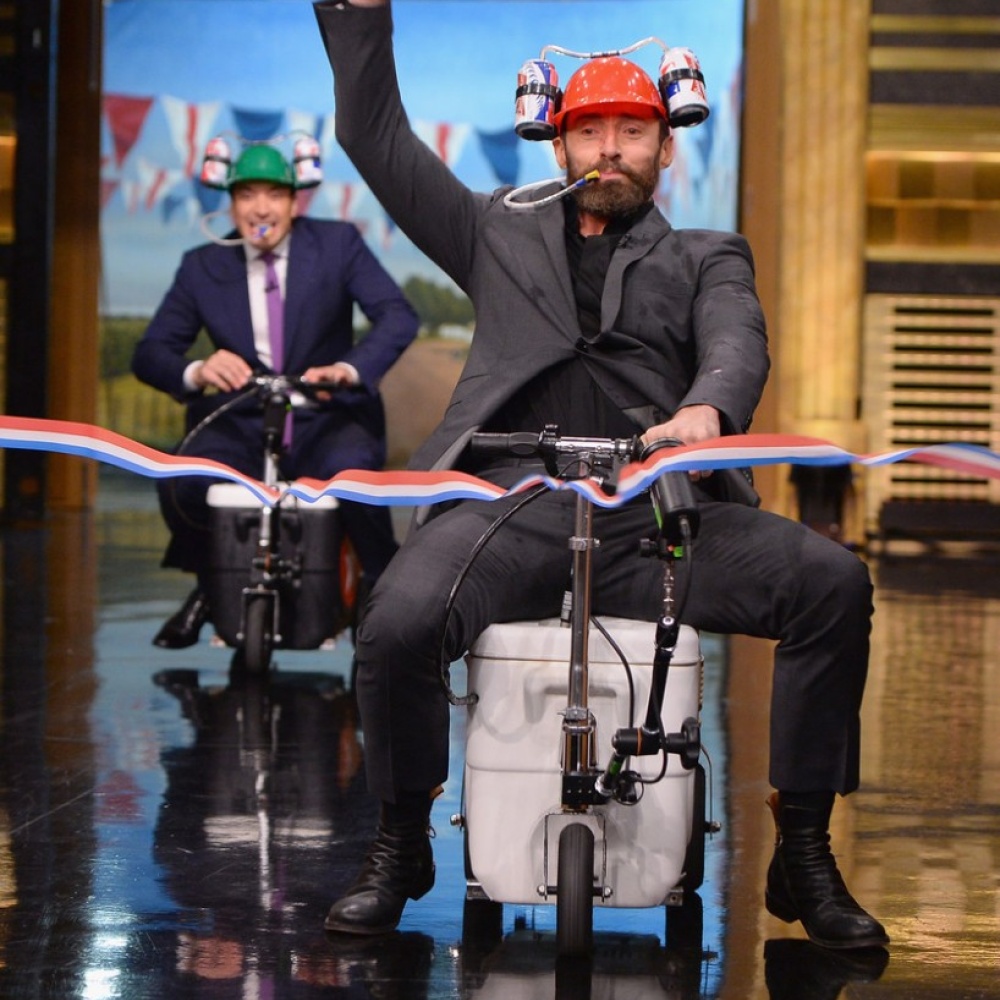 يبدو أن هيو جاكمان قد حن لطفولته ليسابق النجم جيمي فالون في cooler scooter