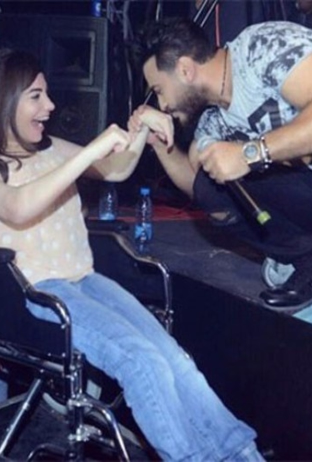 تامر حسني يقبل يد احدى المعجبات من ذوي الاحتياجات الخاصة