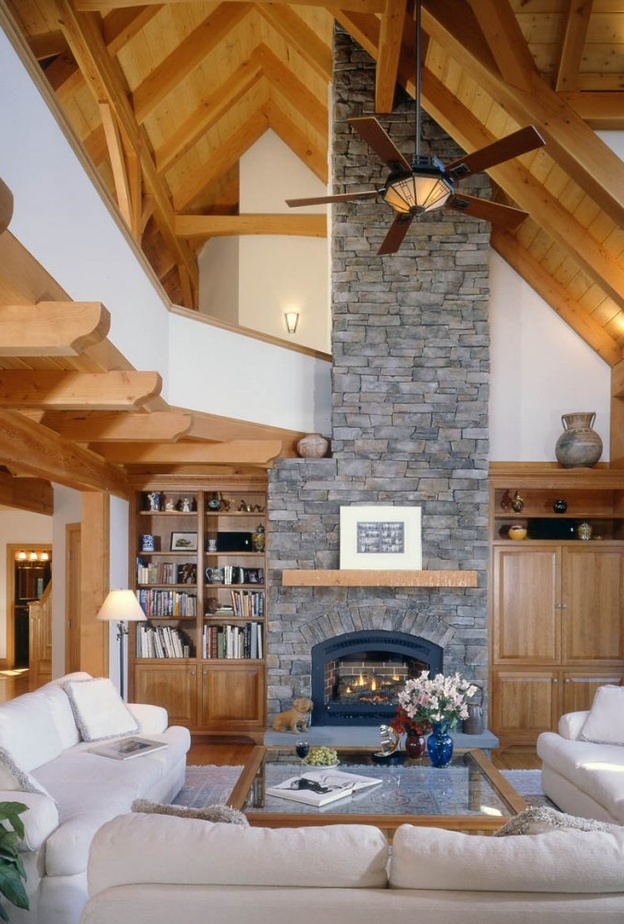 الجدران الحجرية والدرج الخشبي في ديكور غرفة جلوس مودرن