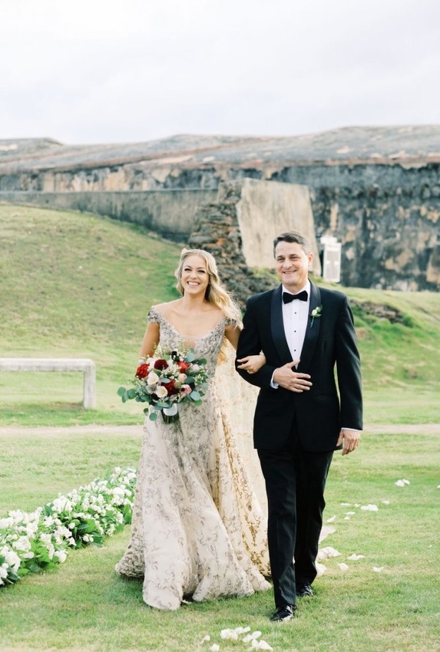  صورة للعروس ووالدها أثناء سيرهما معا على ممر العروس في حفل الزفاف