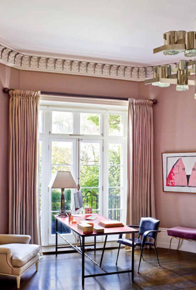 الجدران في زاوية الغرفة باللون الزهري حيث تبدو فيه الستائر جزءا منهم