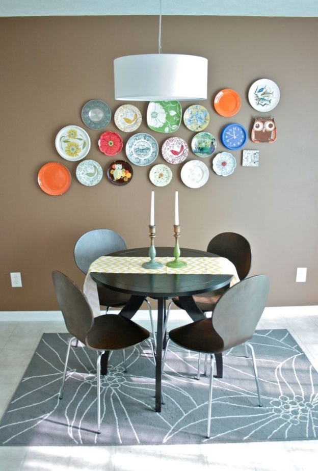 الكراسي المميزة حول طاولة دائرية من الزجاج في غرفة الطعام.