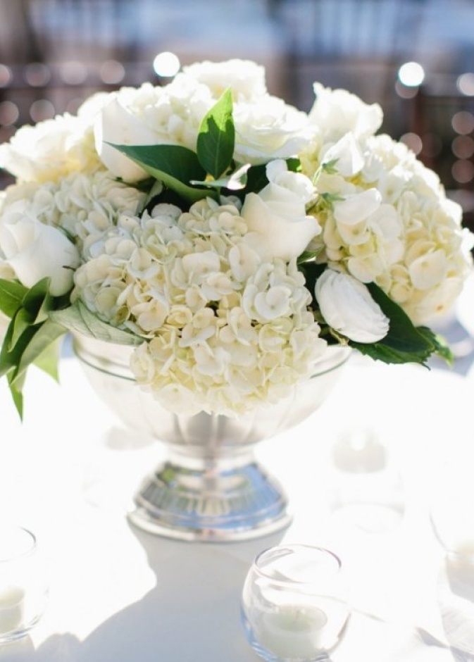 المزهريات المزينة بالورود البيضاء في حفل الزفاف