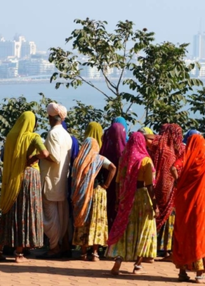 A group of indian women looking at the skyline of mumbai