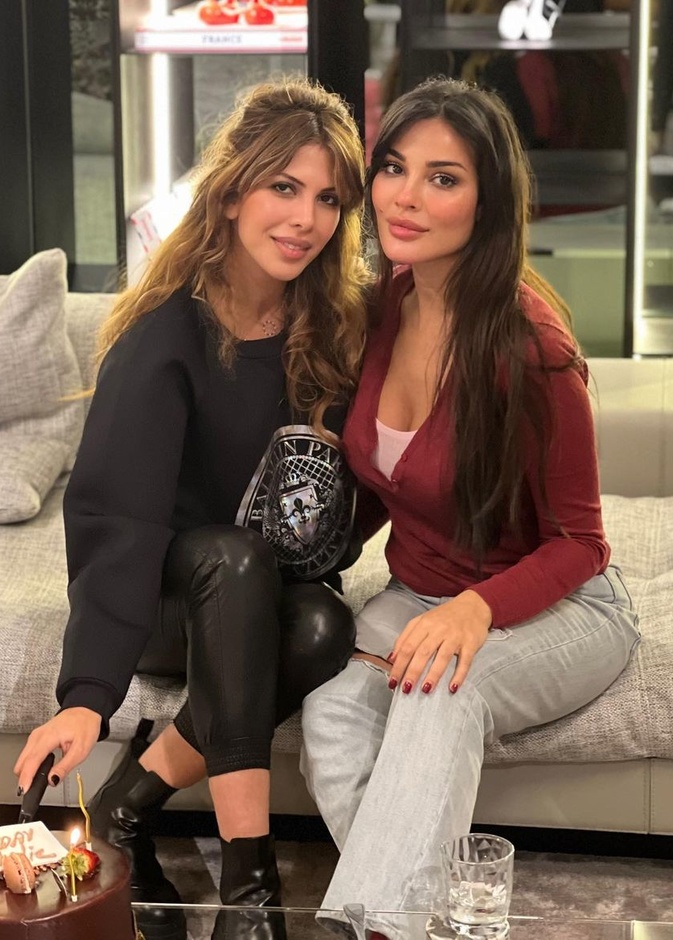 نسّقت نادين البنطلون الدنيم الممزّق مع الكارديغان الأحمر