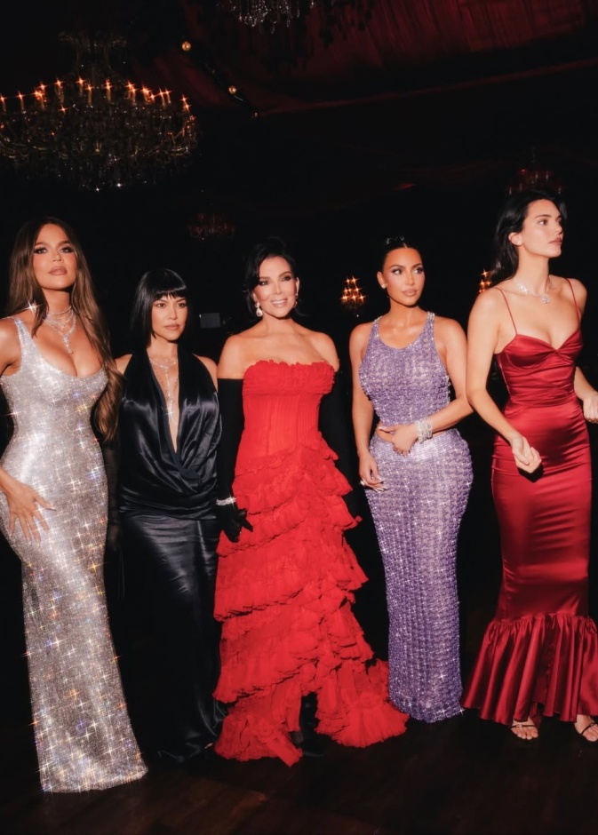 كريس ترتدي فستانا طويلا باللون الأحمر مع بناتها