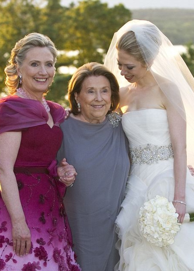 المرشحة على الانتخابات الرئاسية الاميركية هيلاري كلينتون تفاجئ الجميع بالفستان الذي اختارته في زفاف ابنتها تشيلسي من اللون Rosebush ومطرز من الورود النافرة وبتصممي ملفت على العنق