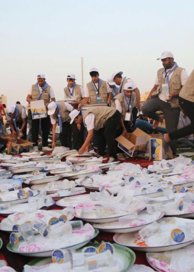 المتطوعين يقومون بتوزيه وجبات الافطار وتجهيزها  