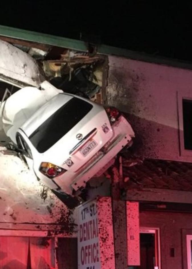 طار السائق الذي كان برفقته راكب آخر بسيارته في الهواء إلى جدار مبنى على جانب الطريق