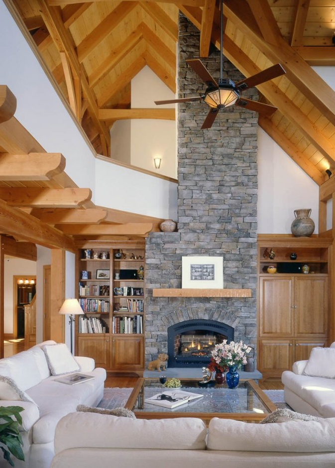 الجدران الحجرية والدرج الخشبي في ديكور غرفة جلوس مودرن