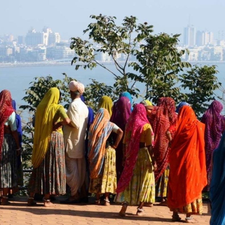 A group of indian women looking at the skyline of mumbai