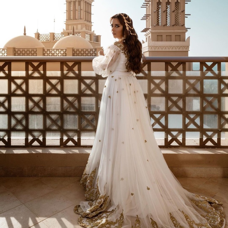 بلقيس بفستان ابيض مطرظ بالذهبي 