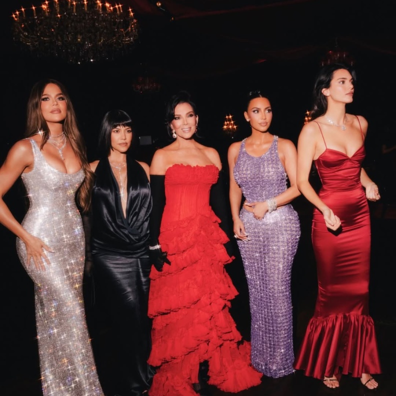 كريس ترتدي فستانا طويلا باللون الأحمر مع بناتها