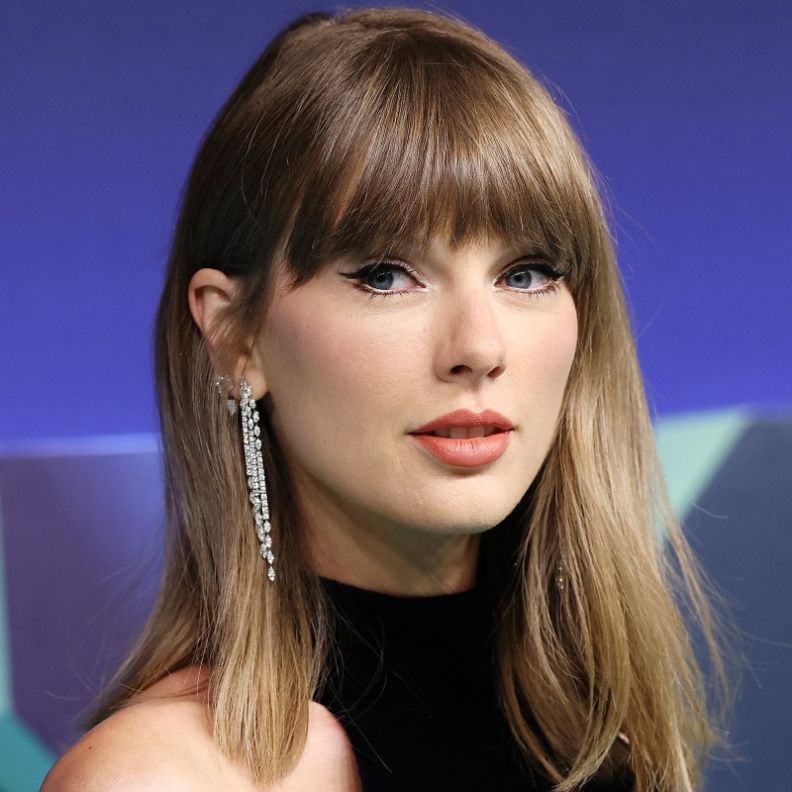 إطلالة Taylor Swift برسمات المكياج البني البراق مع أحمر الشفاه المشمشي
