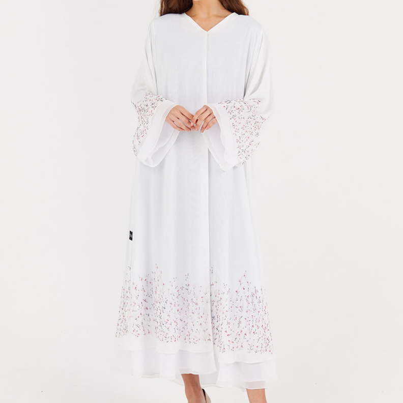 نعومة وأنوثة العباية باللون الأبيض مع لمسات جذابة من تصميم عبايات Bless