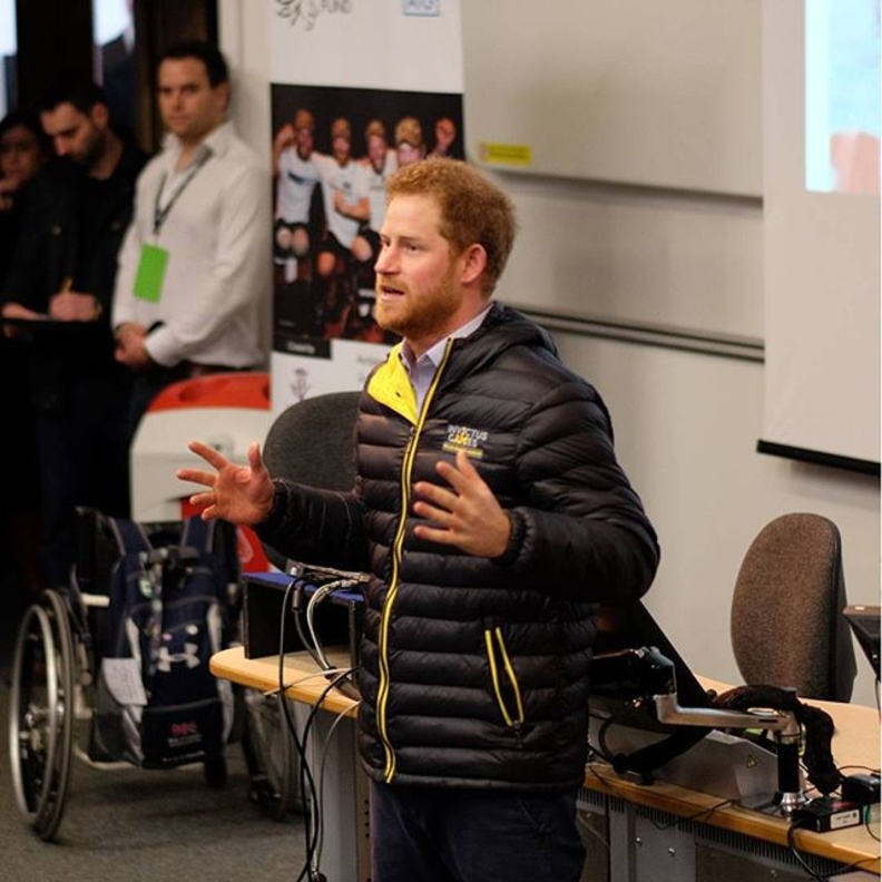 بالصور.. الأمير هاري يساعد امرأة معاقة