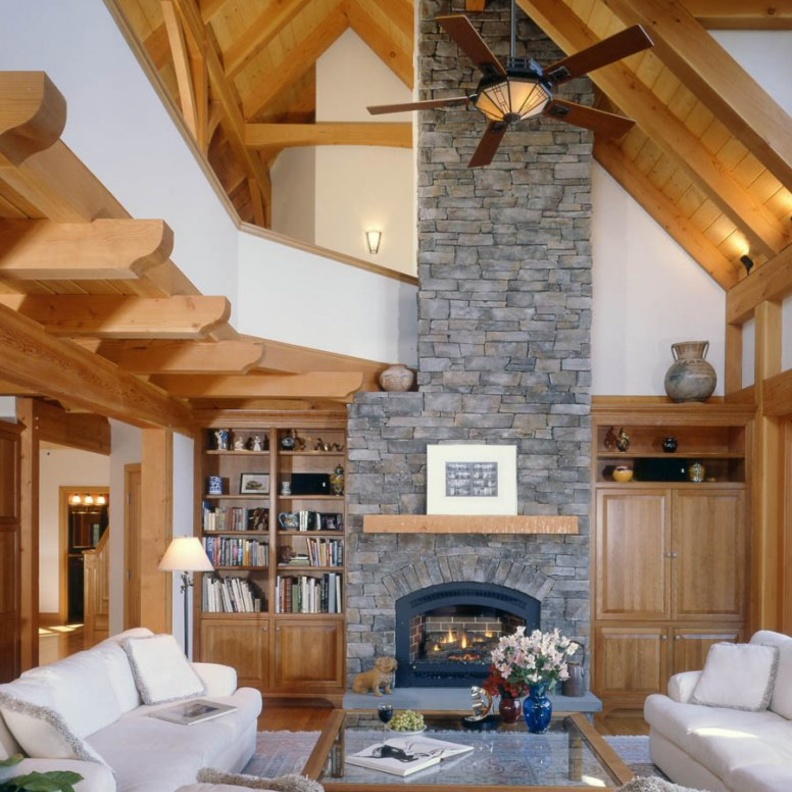 الجدران الحجرية والدرج الخشبي في ديكور غرفة جلوس مودرن