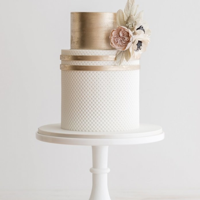 كعكة زفاف بيضاء مع زينة ناعمة وأنيقة