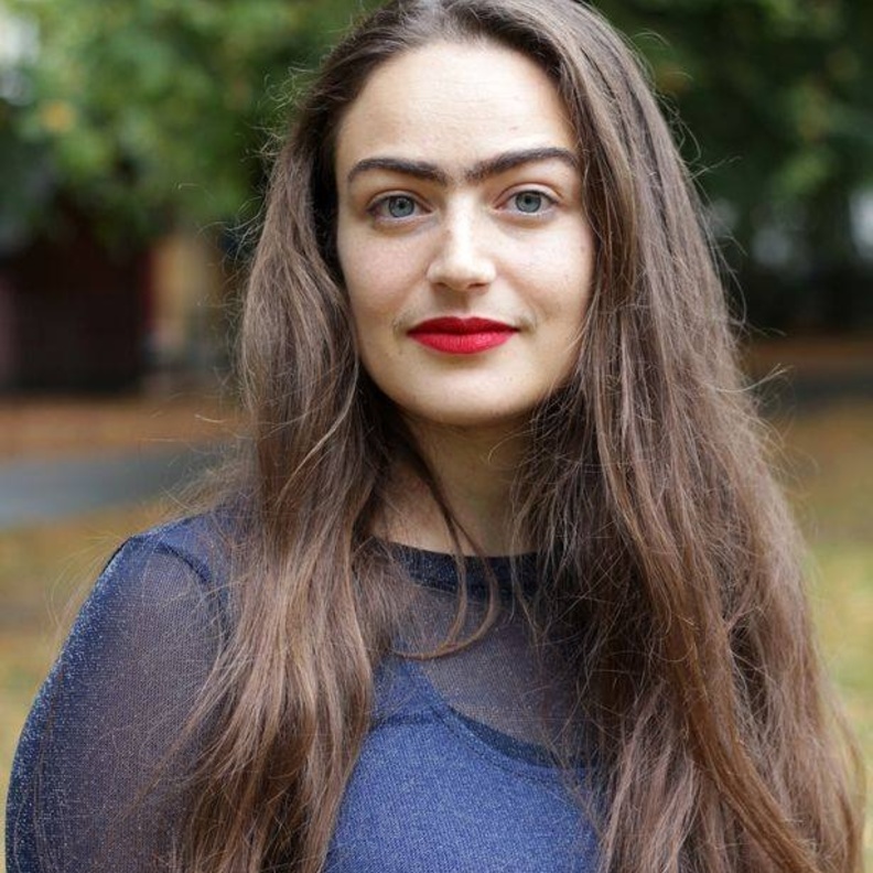 فتاة دانماركية تتحدى معايير الجمال بحواجب متصلين وشارب