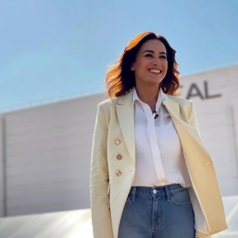 نسّقت ياسمين البليرز بلون كريميّ  مع القميص الأبيض والبنطلون الدنيم