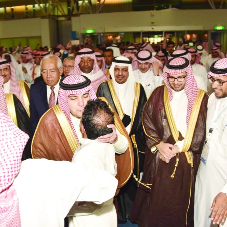 وزير الثقافة والإعلام عادل الطريفي أثناء تقبيل جبين المصور عبد العزيز اليوسف